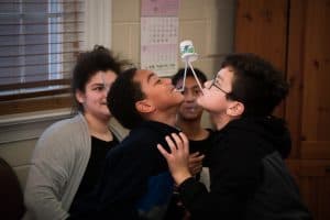 Shabbat School Children Try to Pass A Cup With Straws